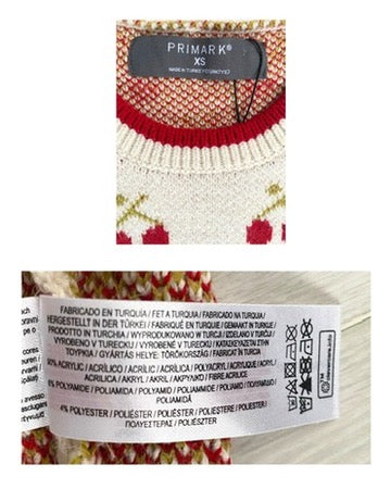 Close-up of a Primark sweater label with text and pattern details.