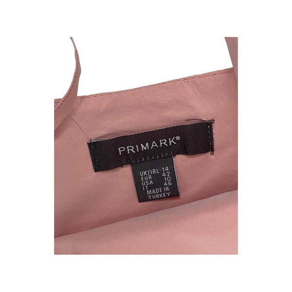 Pink garment with a Primark label on a white background