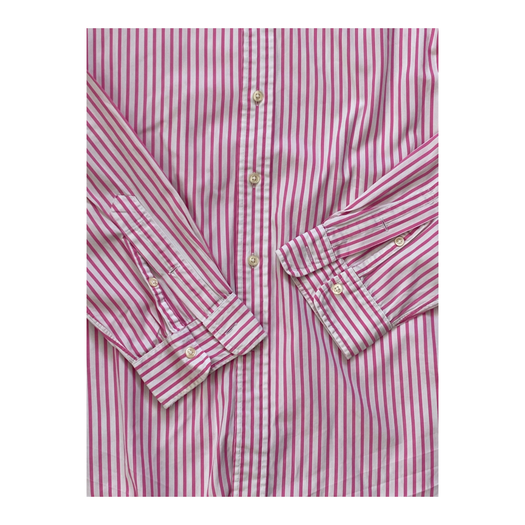Folded pink and white striped shirt on a white background
