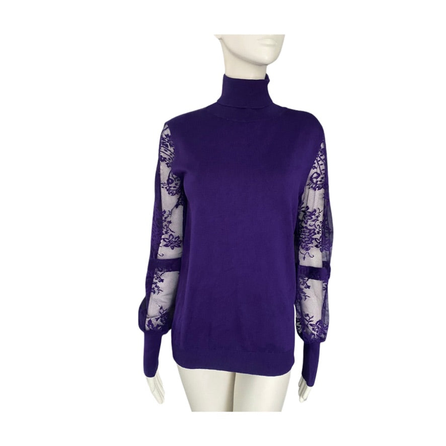 Purple turtleneck sweater with sheer sleeves on a mannequin against a white background