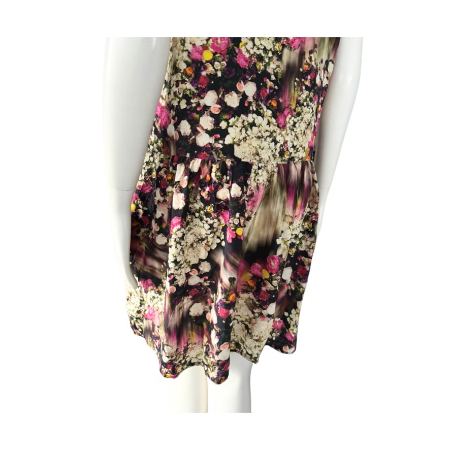 Floral patterned dress on a mannequin against a white background