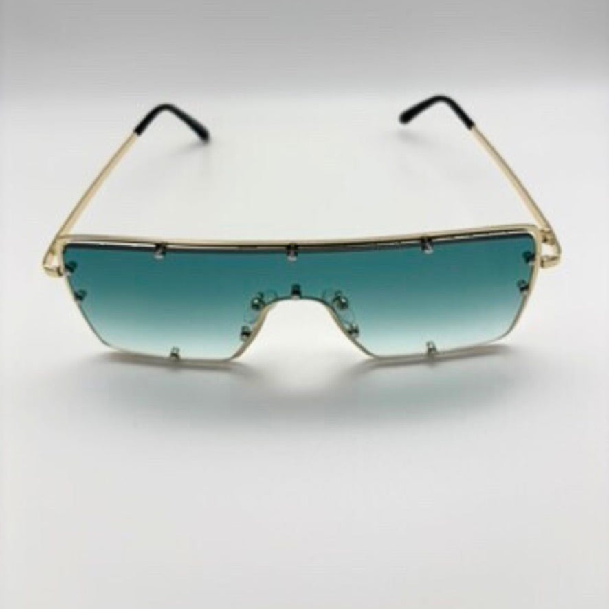 Sunglasses with gold frame and gradient green lenses on a white background