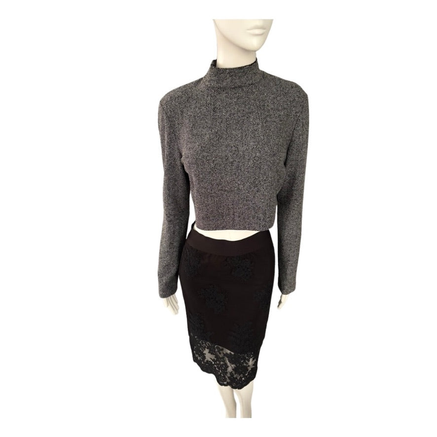 Mannequin wearing a gray long-sleeve top and black lace skirt on a white background