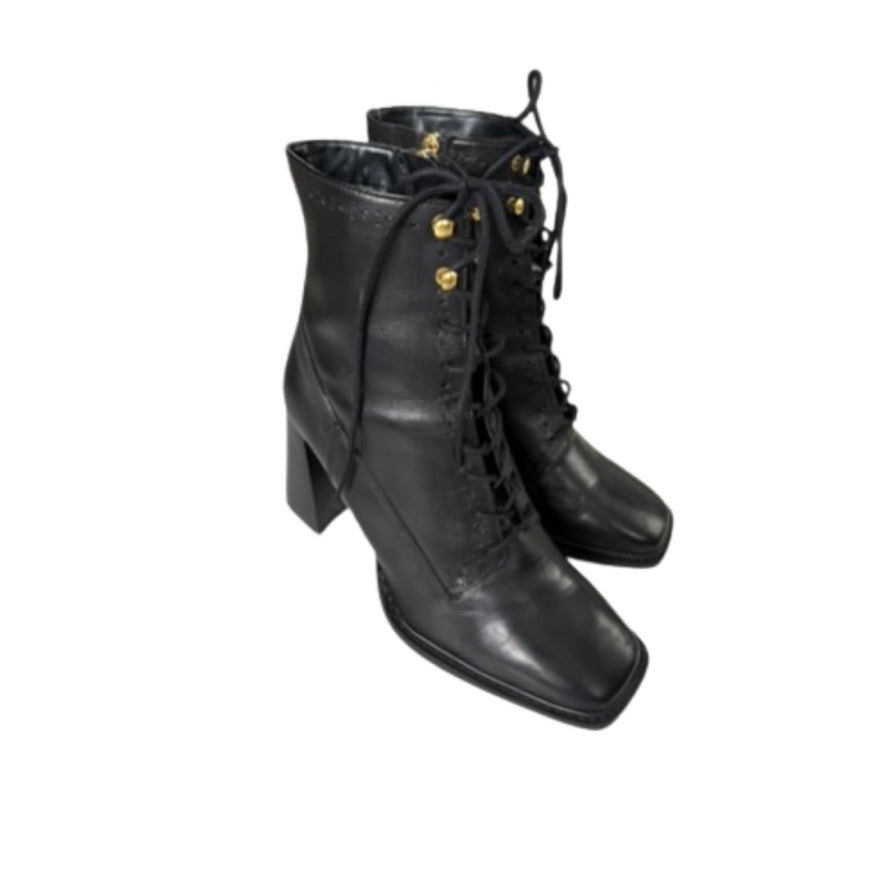 Pair of black leather lace-up boots on a white background