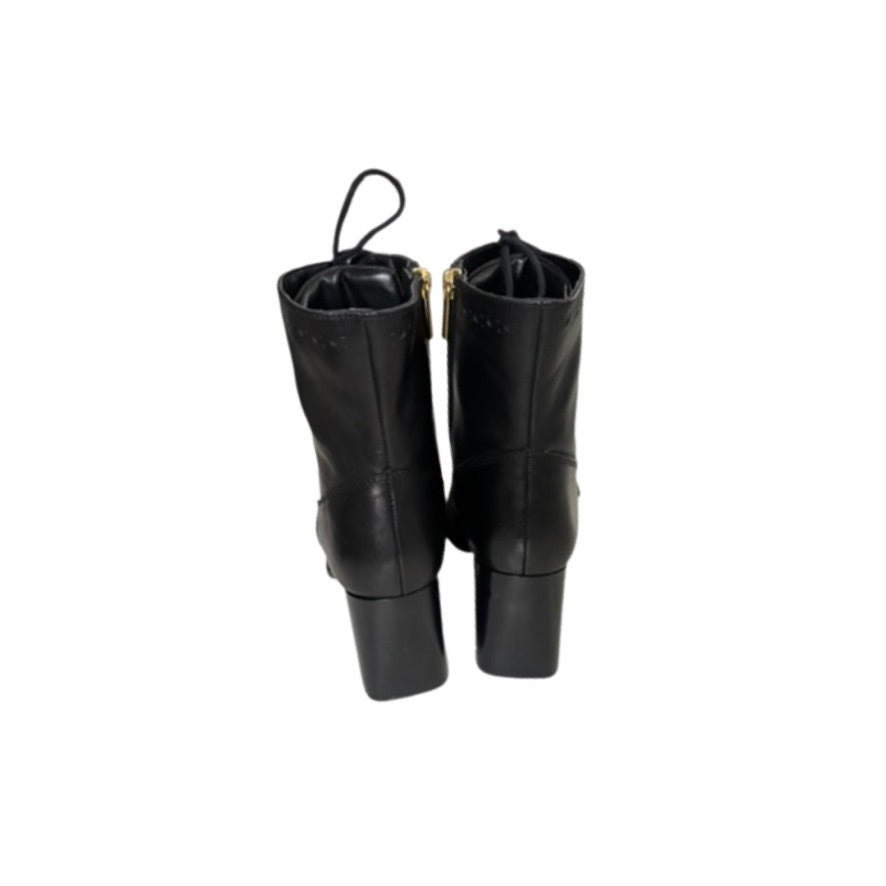 Pair of black leather boots on a white background