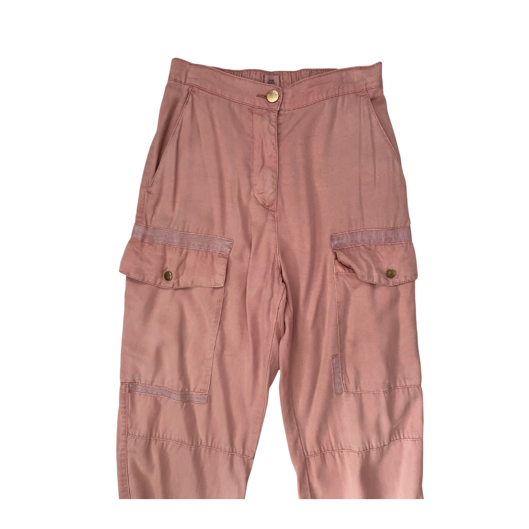 Pink cargo pants on a white background