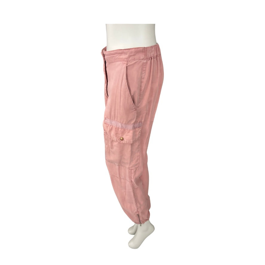 Pink cargo pants on a mannequin against a white background