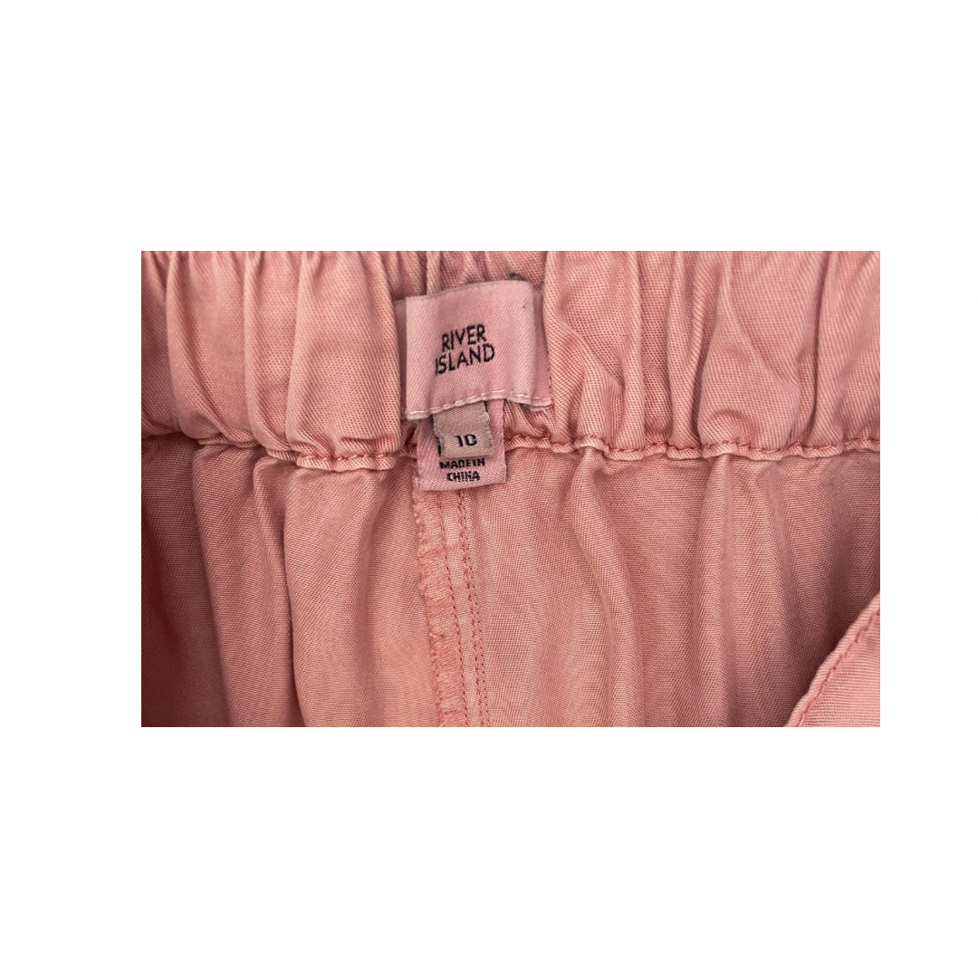 Pink fabric with a 'River Island' label on a white background