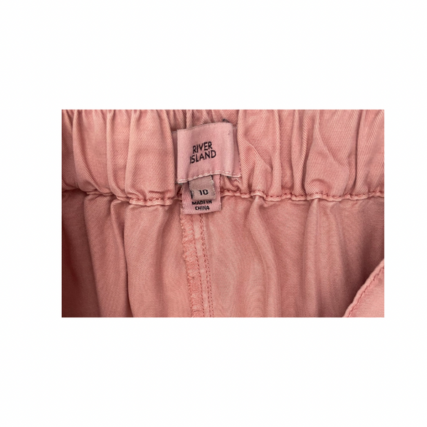 Pink fabric with a 'River Island' label on a white background