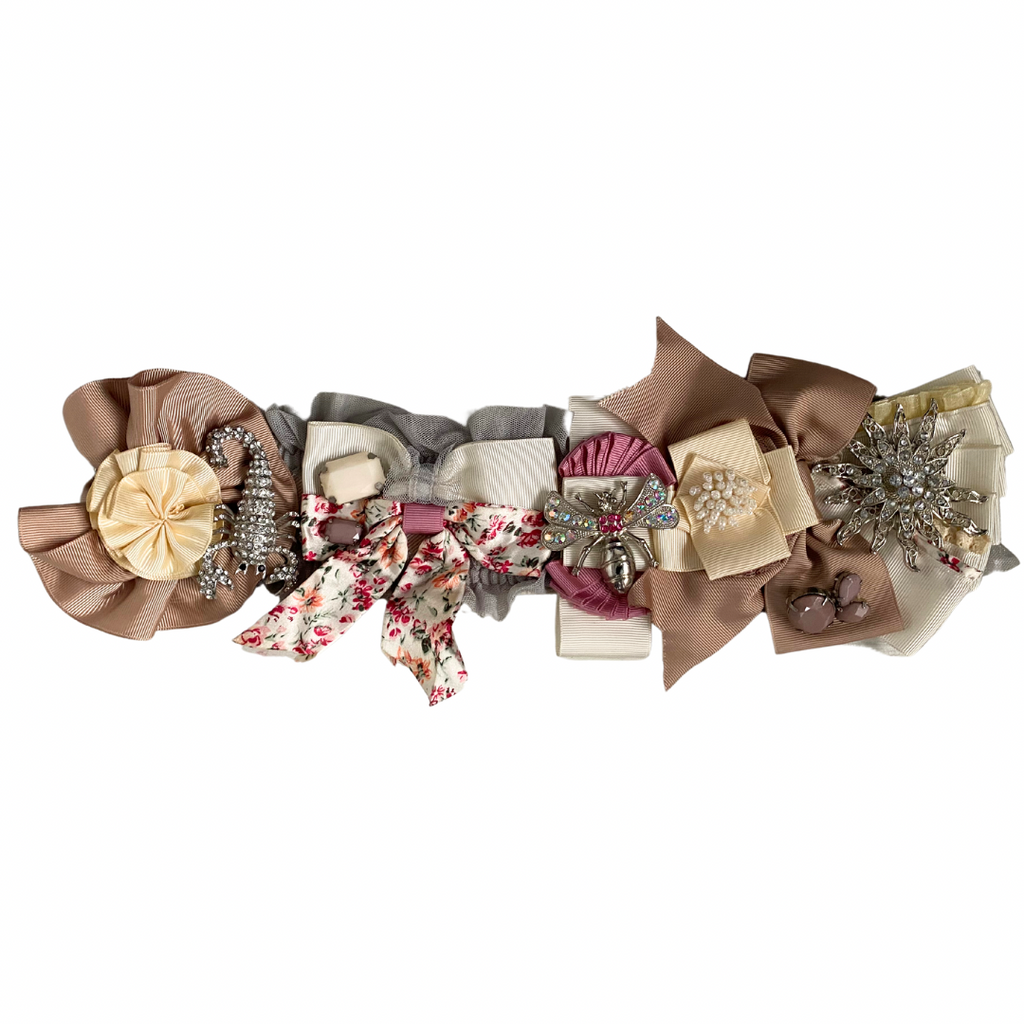 A preloved multicolored floral belt with rosettes and brooches, featuring cream, pink, beige, and green tones, with silver-tone hardware.