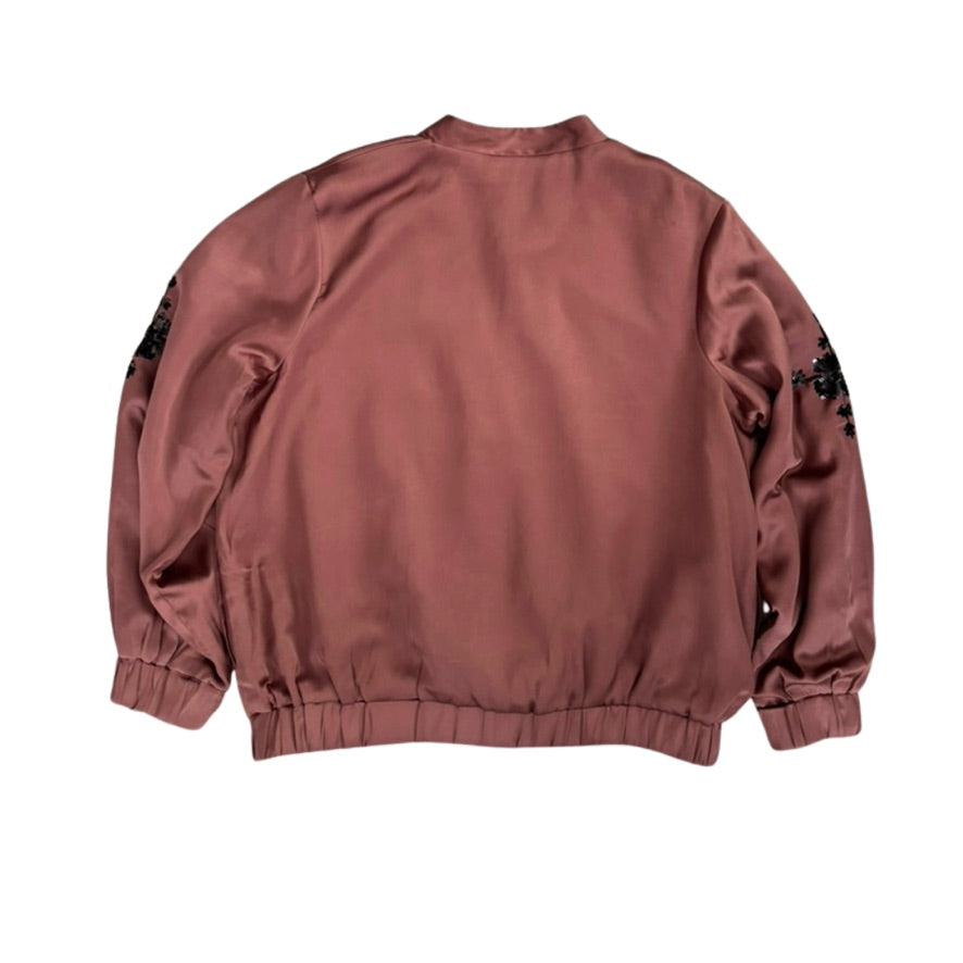 Back view of a maroon jacket with black patterns on sleeves against a white background
