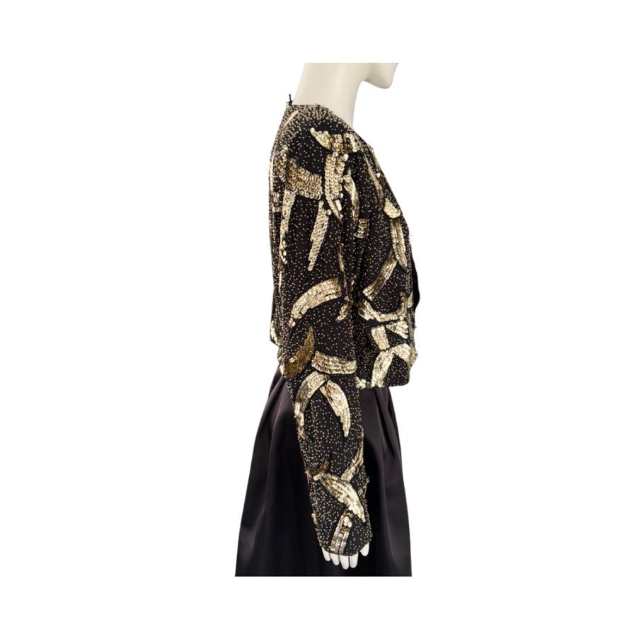 Mannequin wearing a black and gold patterned outfit on a white background