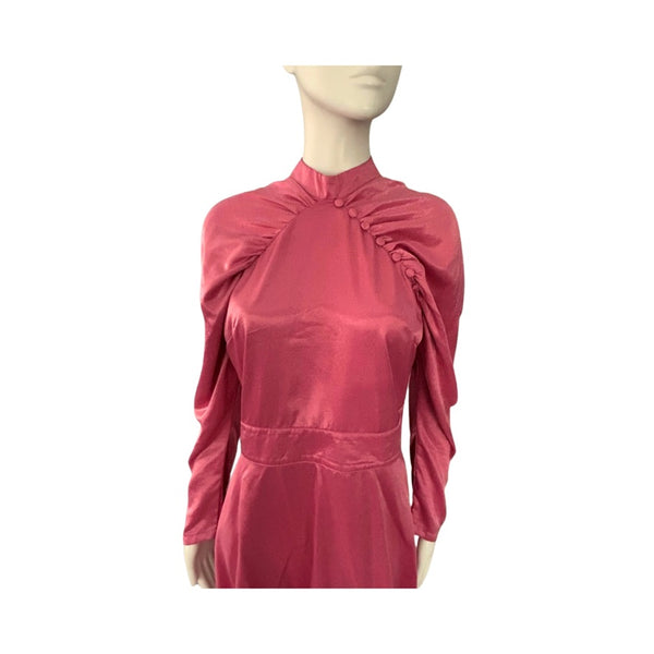 pink dress on a mannequin against a white background