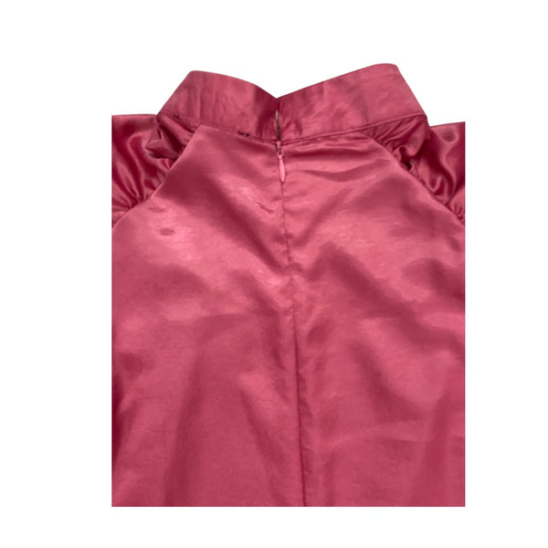 Close-up of a pink satin garment on a white background