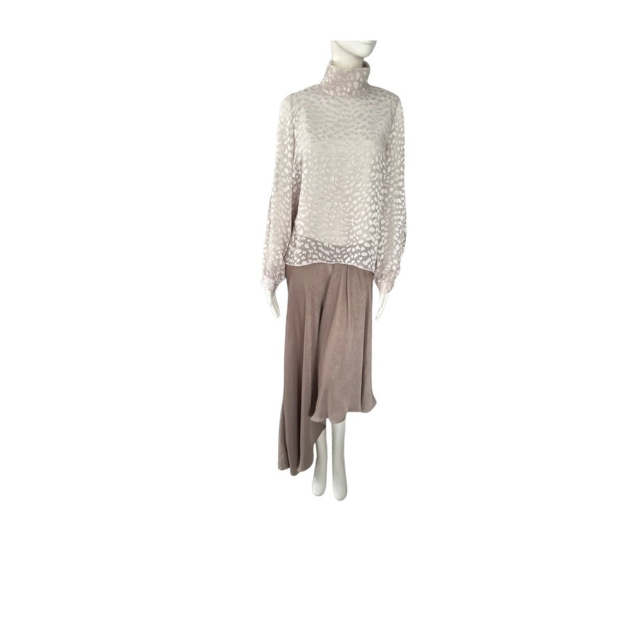 Mannequin wearing a two-tone dress with a light-colored top and brown skirt on a white background