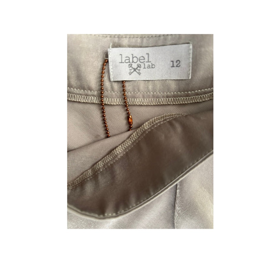 Close-up of a label on a beige garment with 'label & lab' branding.