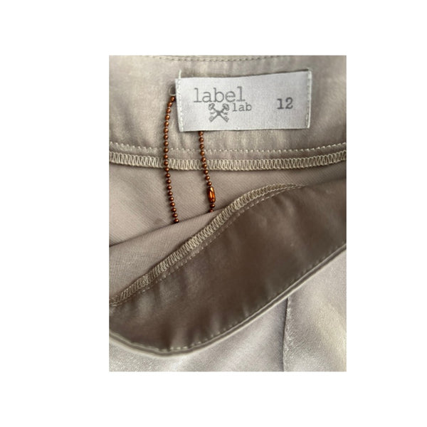 Close-up of a label on a beige garment with 'label & lab' branding.