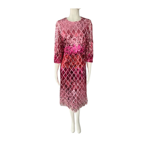 Mannequin wearing a pink and red patterned dress on a white background