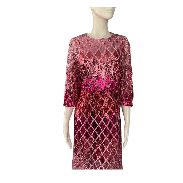 Mannequin wearing a red and pink patterned dress on a white background