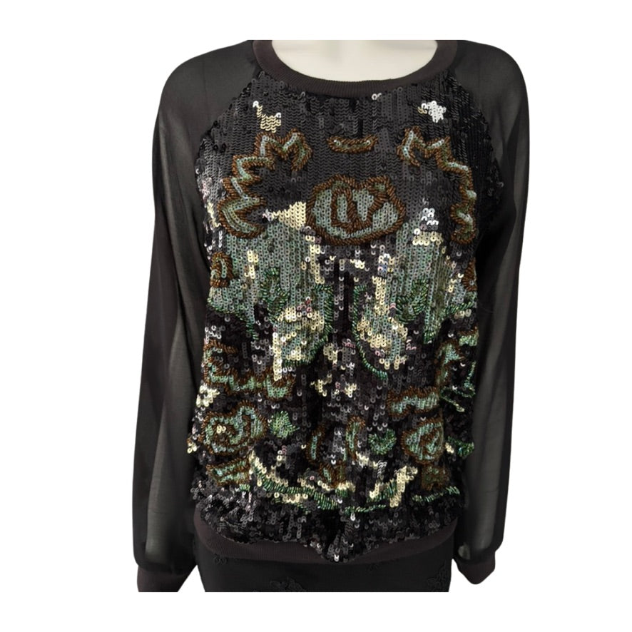 Black sweater with sequin design on a white background