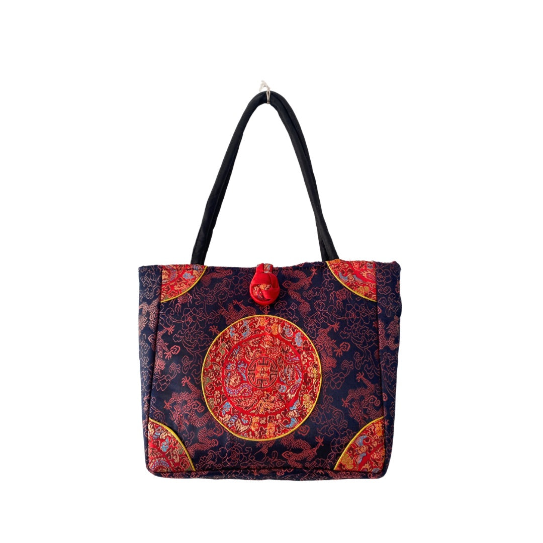 A navy-colored Silk Vintage Mini Tote Bag with embroidered dragon pattern in contrasting red and gold, featuring double top handles, a large knot feature, and a single top loop fastening.