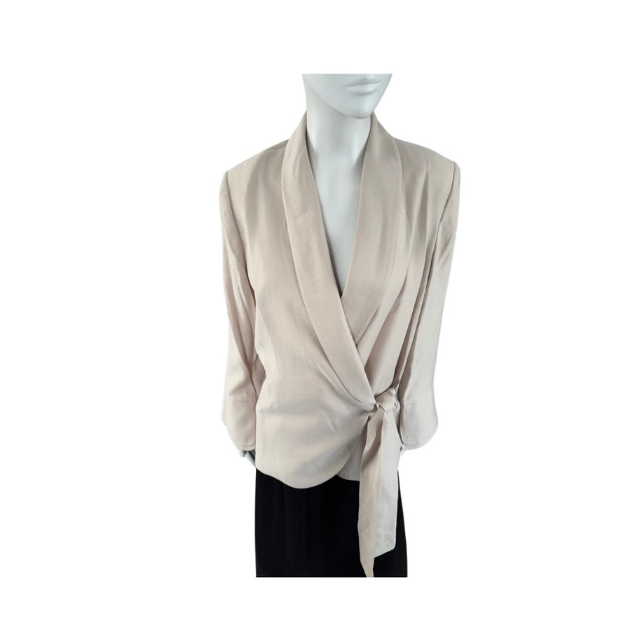 Beige wrap-style top on a mannequin against a white background