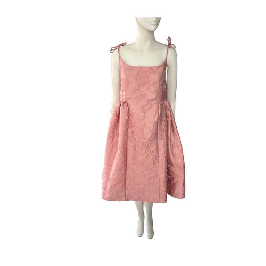 Pink dress on a mannequin against a white background