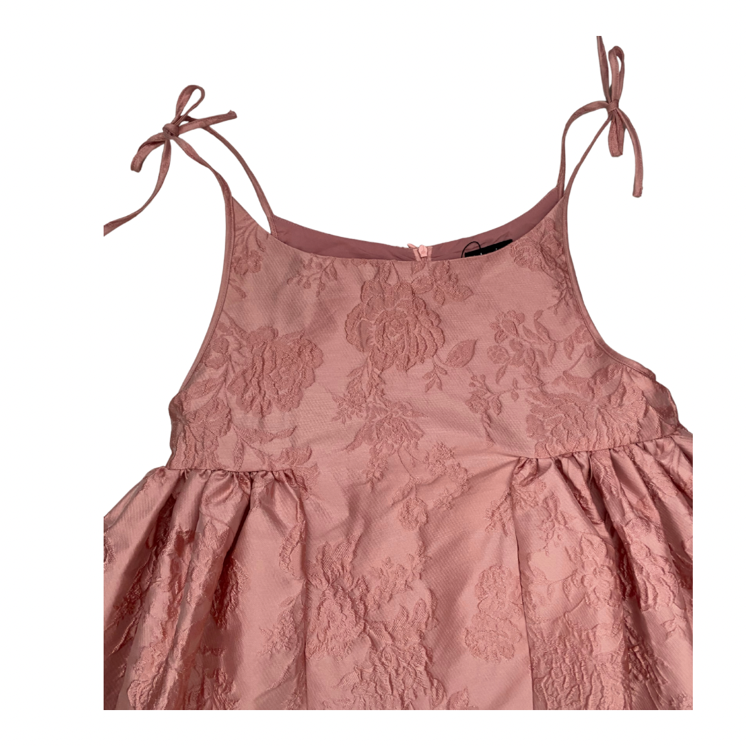 Pink floral dress with thin straps on a white background