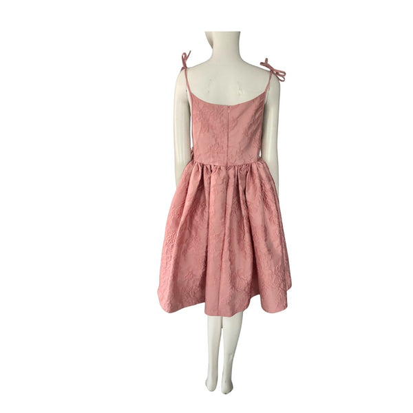 Pink dress on a mannequin against a white background