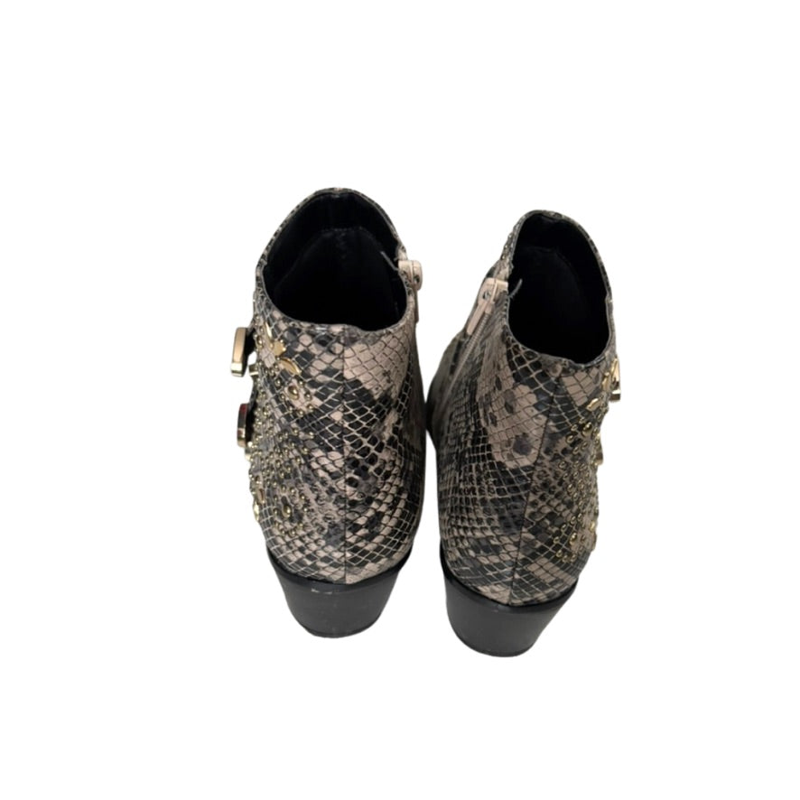 Pair of snake print boots on a white background