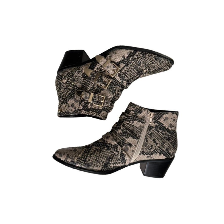 Pair of snakeskin-patterned ankle boots on a white background