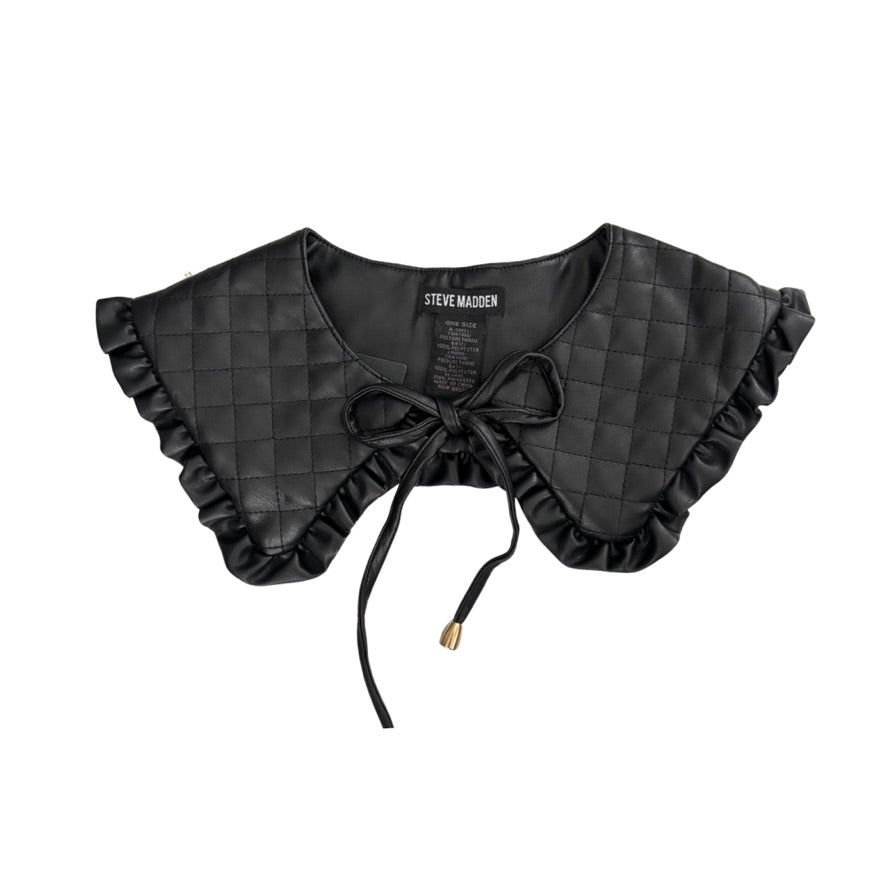 Black quilted collar with ruffles and a bow on a white background