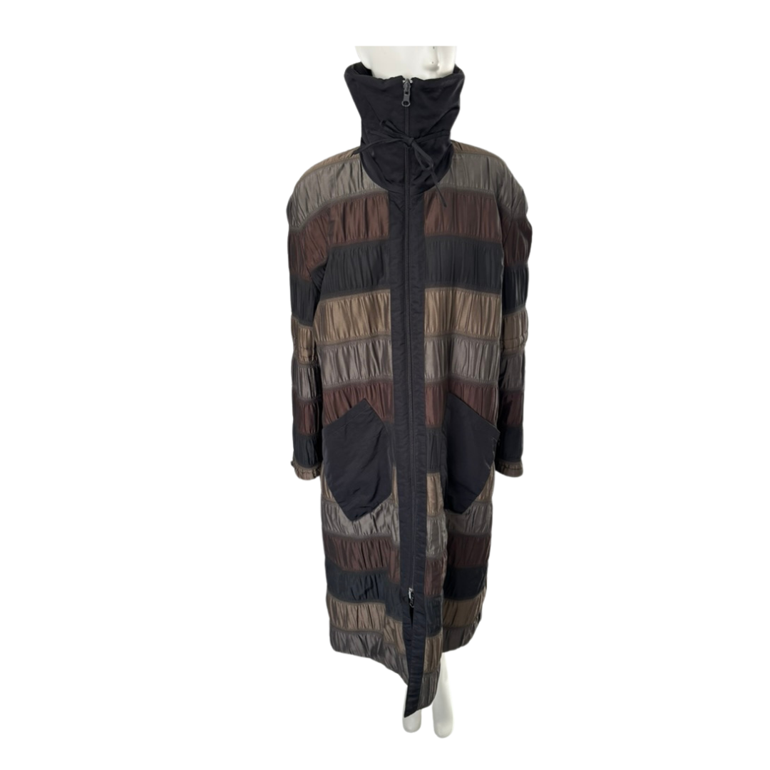 Long, patterned coat on a mannequin against a white background