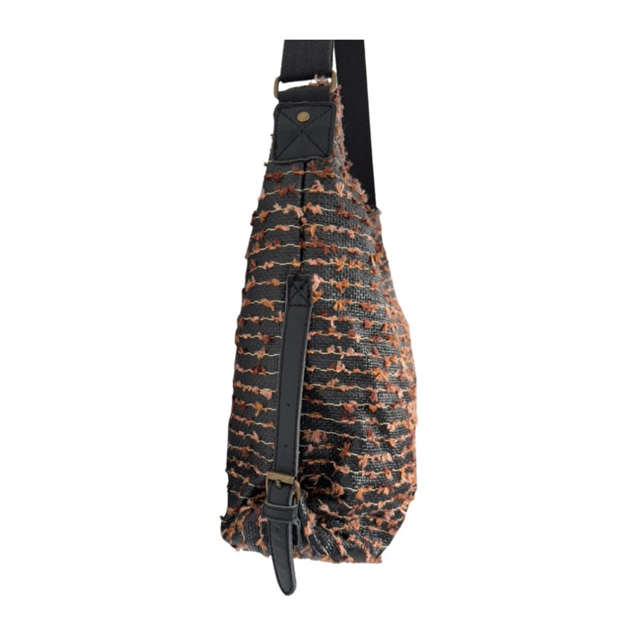 Sling bag with textured pattern on a white background