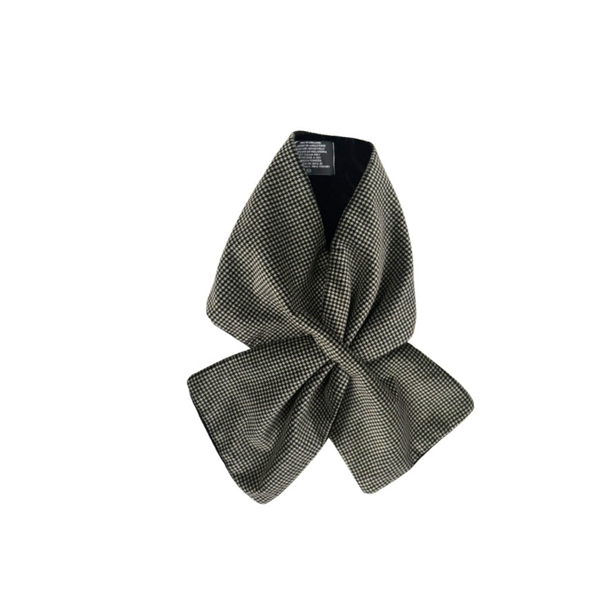Black and beige checkered bow tie on a white background