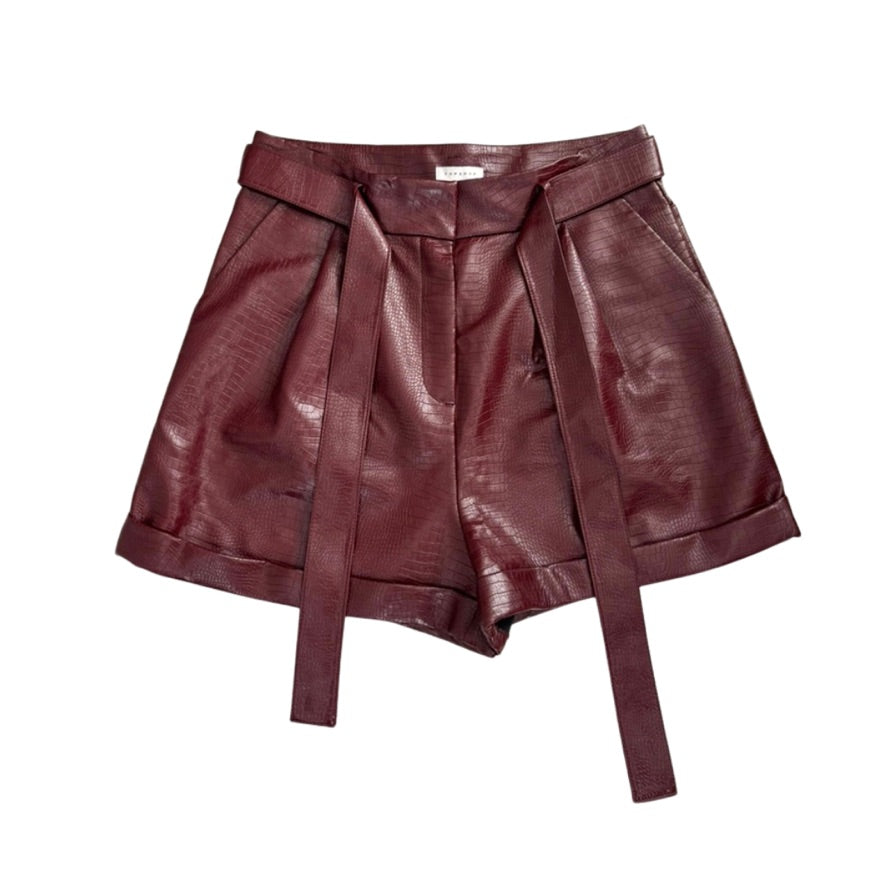 Burgundy leather shorts with a belt on a white background