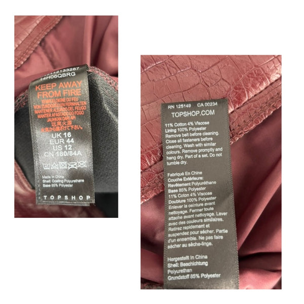 Close-up of a Topshop label on a burgundy textured fabric background