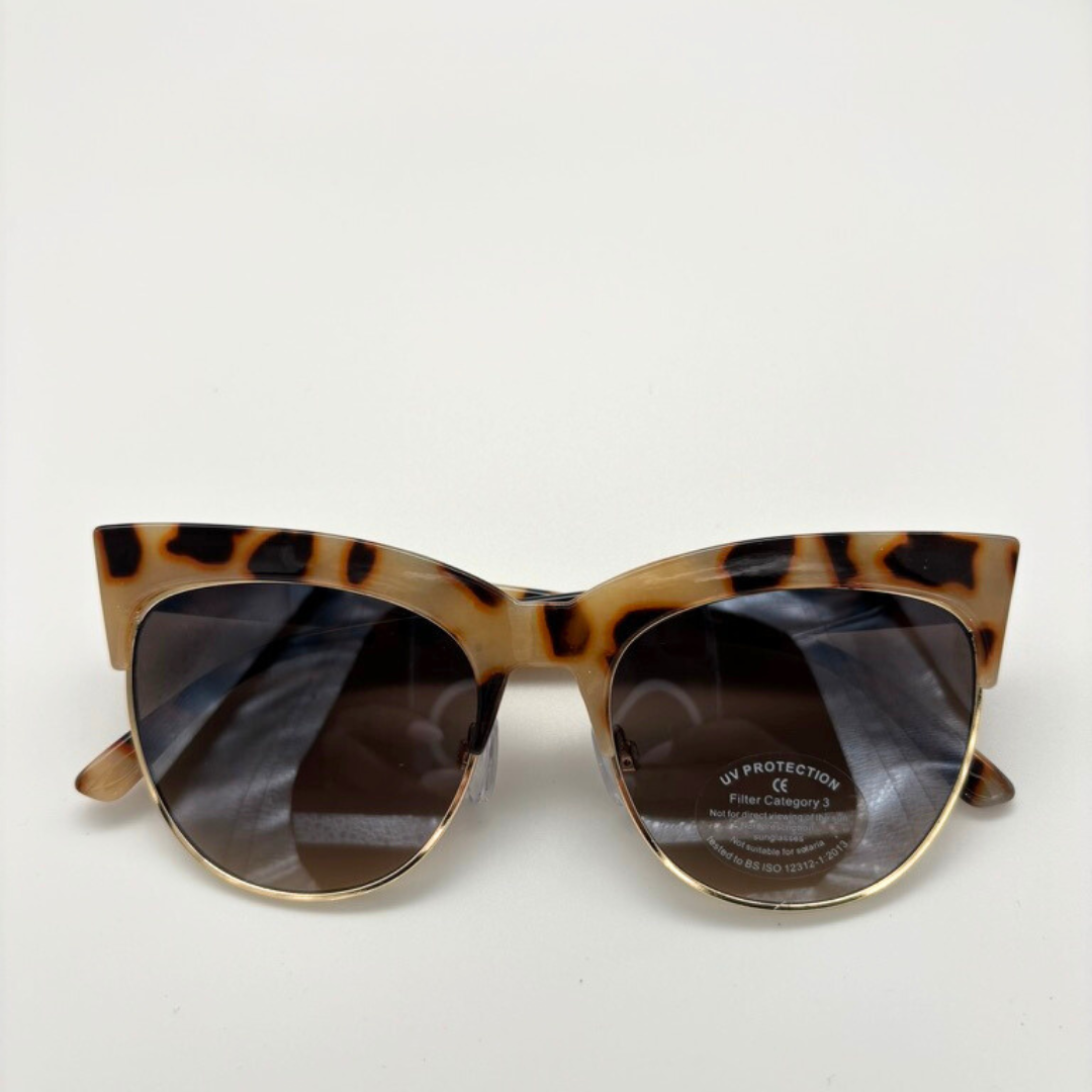 Cat-eye sunglasses with tortoiseshell frame on a white background
