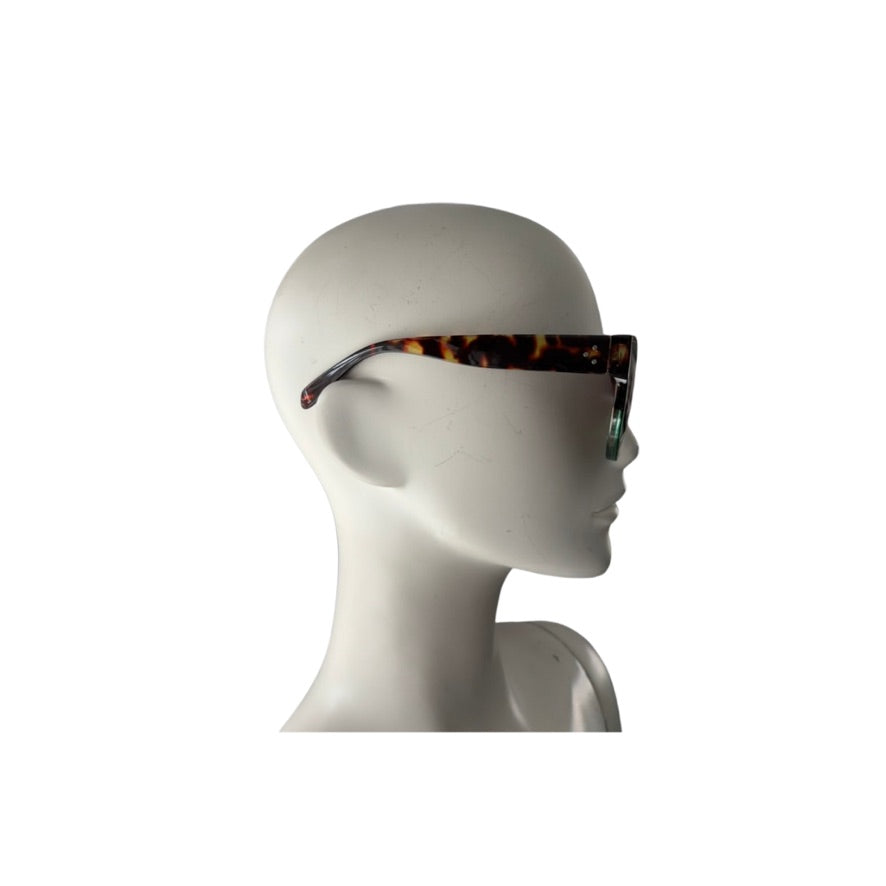 Sunglasses with tortoiseshell frame on a mannequin head against a white background