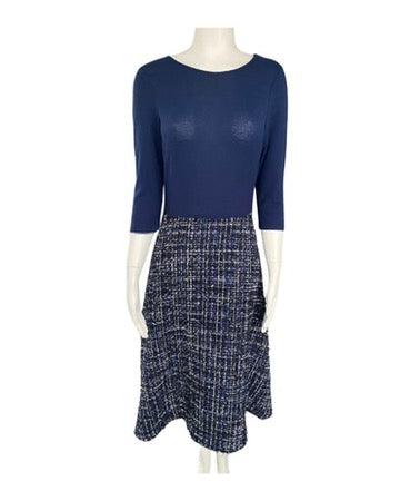 Mannequin wearing a navy blue top and patterned skirt on a white background