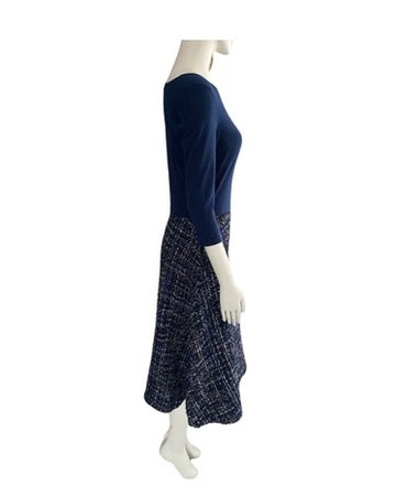 Navy blue dress with patterned skirt on a mannequin against a white background