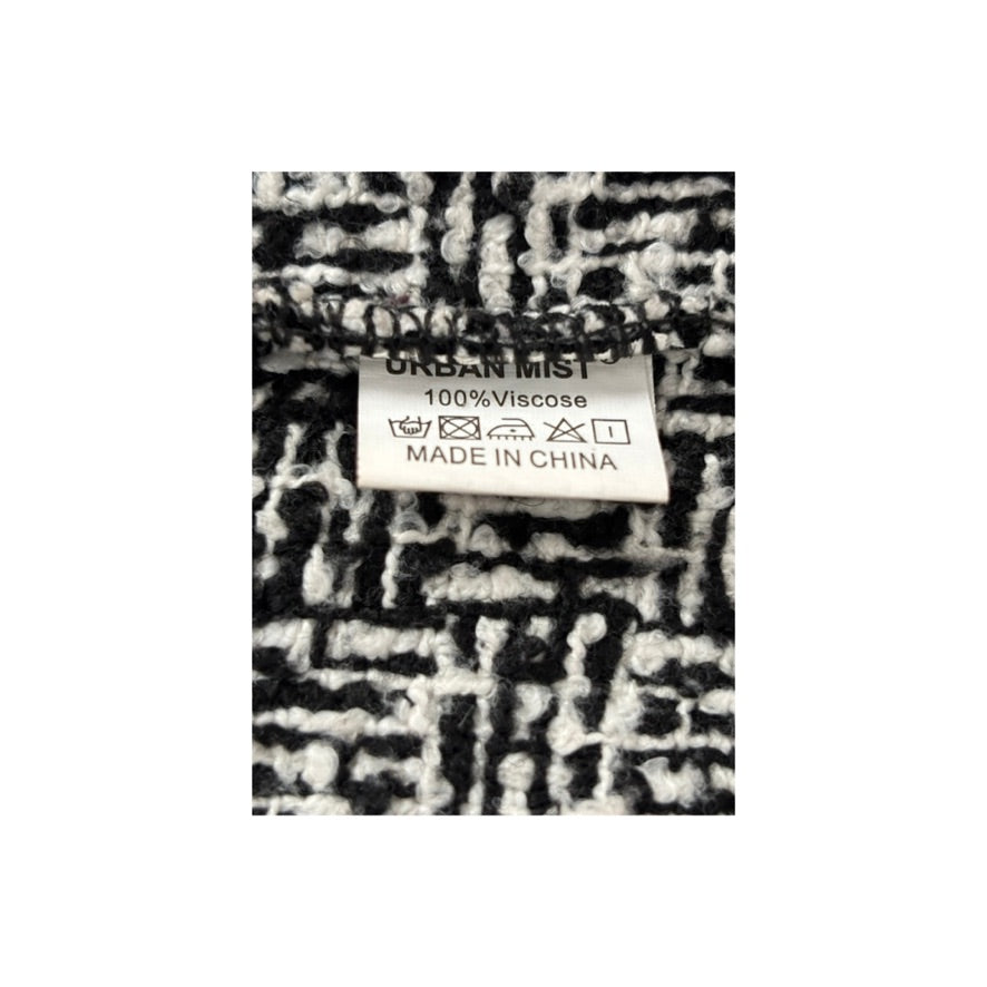 Black and white checkered fabric with a label on a white background