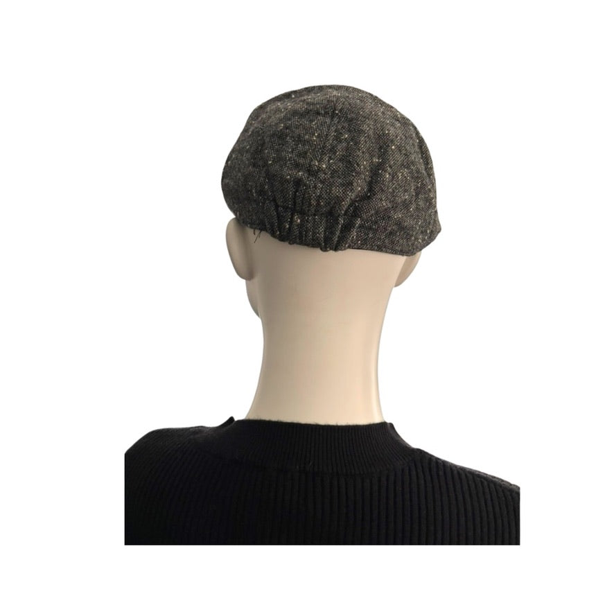 back of Mannequin head wearing a textured grey flatcap on a white background