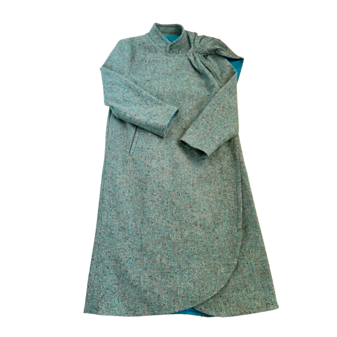 Green textured coat with a bow detail on a white background