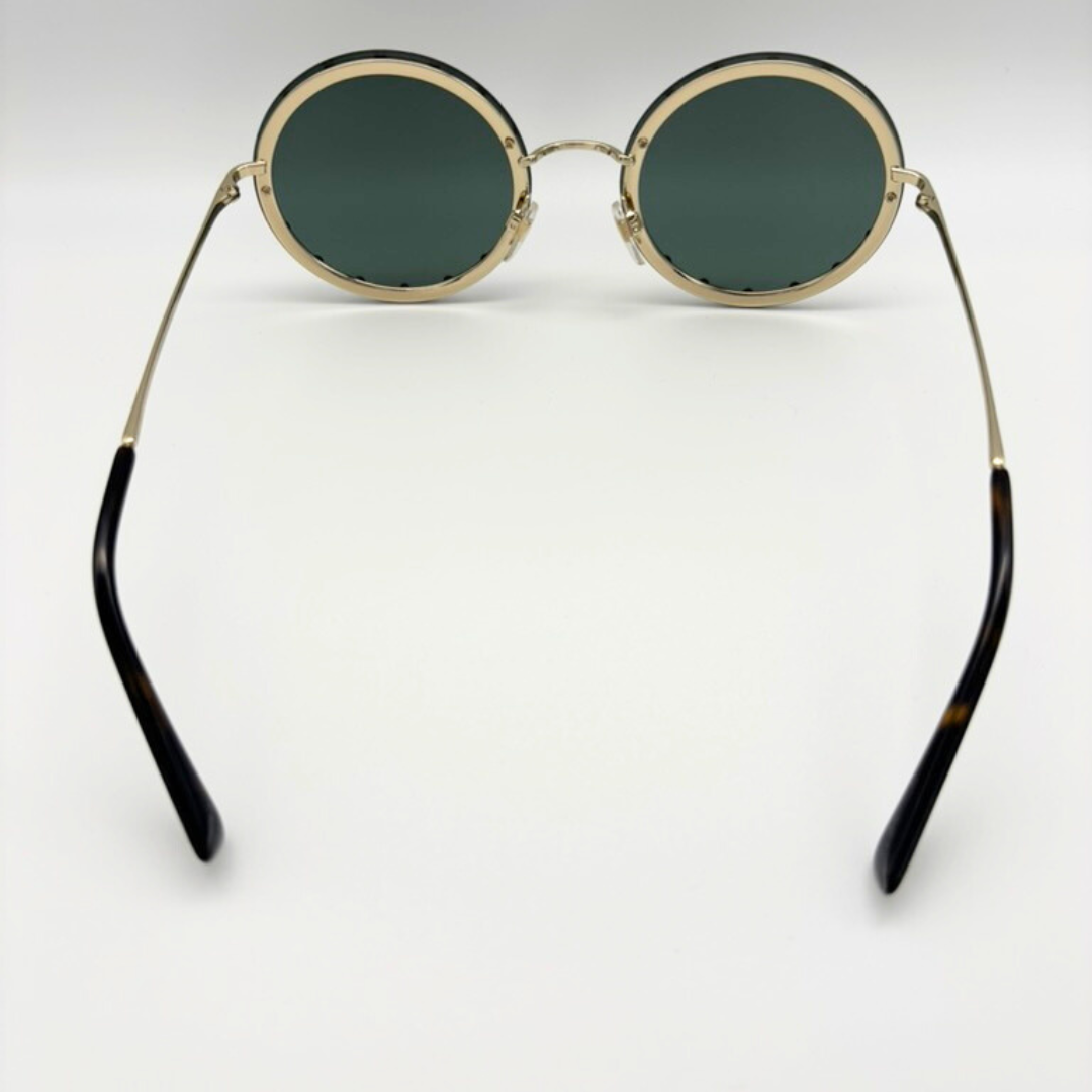 Round sunglasses with gold frames and black accents on a white background