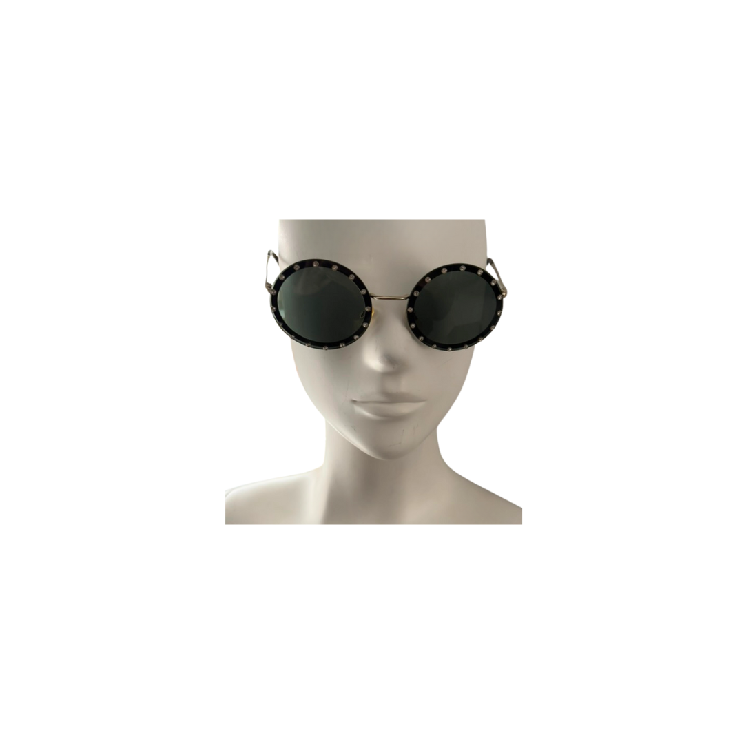 Round sunglasses on a mannequin head against a white background