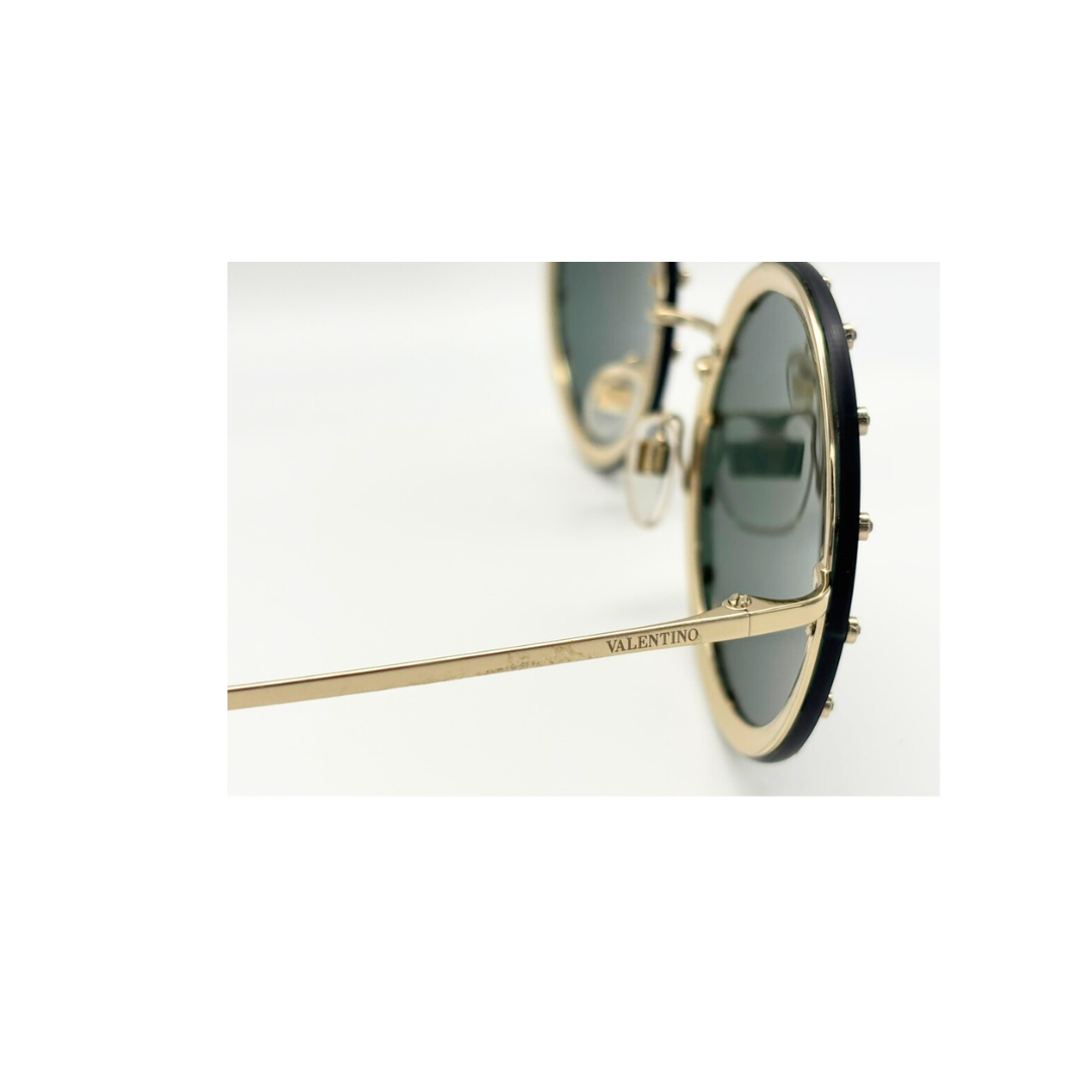 Sunglasses with gold frame and black rim on a white background