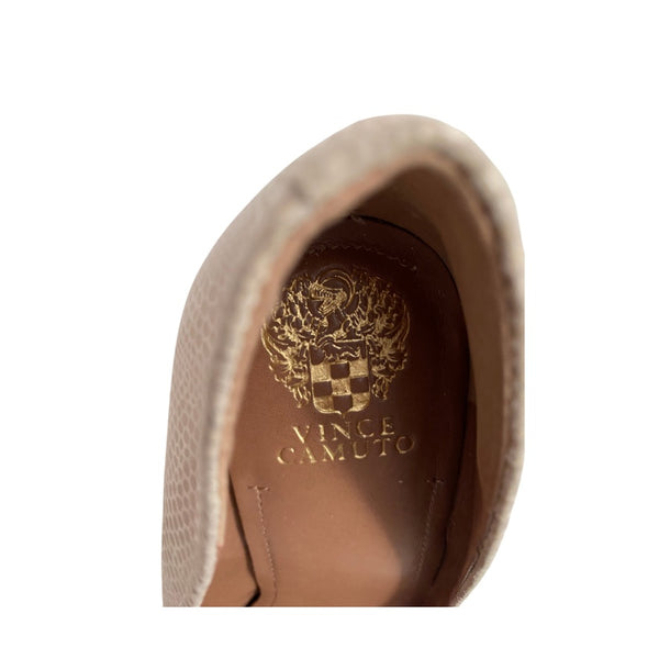 Close-up of a brown shoe inner sole with 'Vince Camuto' logo on a white background