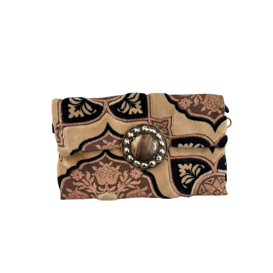 Patterned clutch bag with decorative buckle on a white background