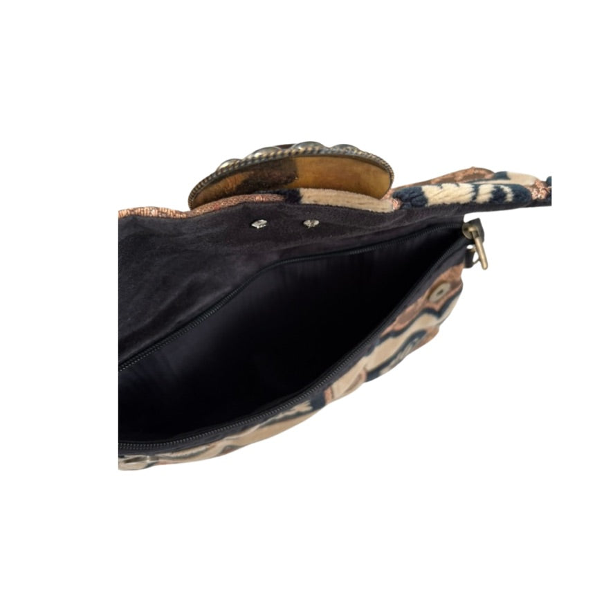 Clutch bag with animal print exterior and black interior on a white background